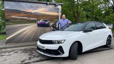 Auto Express products editor Kim Adams standing behind the Vauxhall Astra GSe